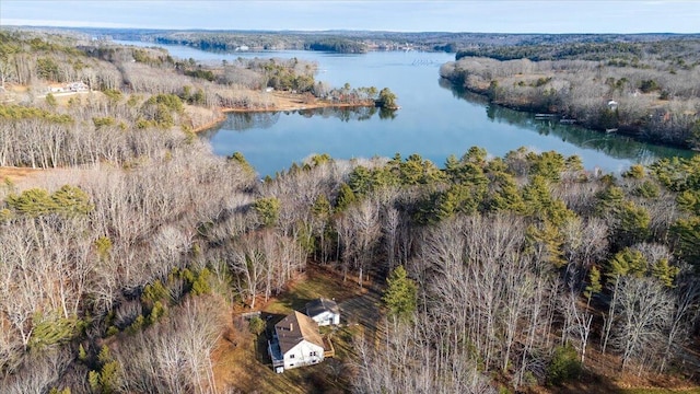 aerial view with a wooded view and a water view