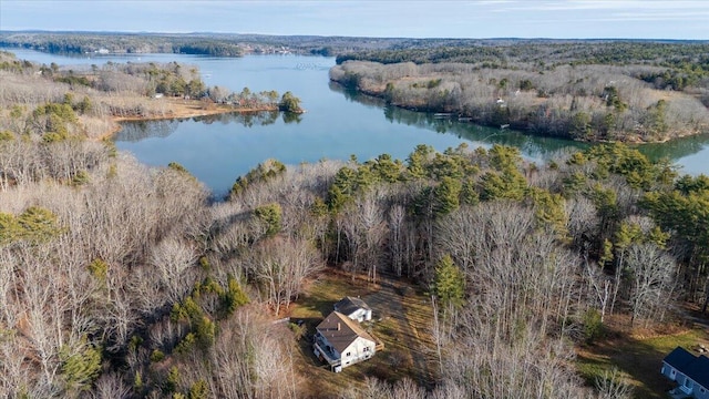 birds eye view of property featuring a view of trees and a water view