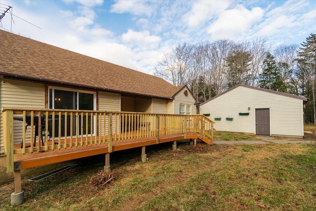 back of house featuring a wooden deck and roof with shingles