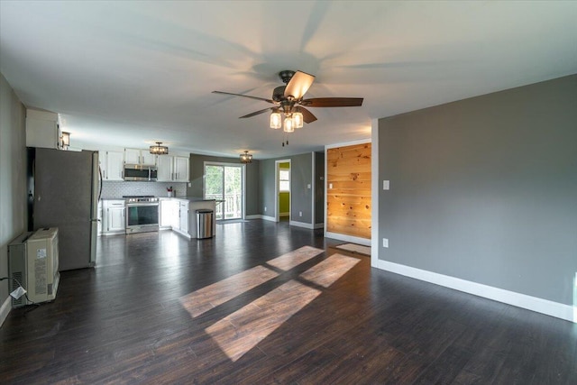 unfurnished living room with dark wood-style floors, baseboards, and ceiling fan