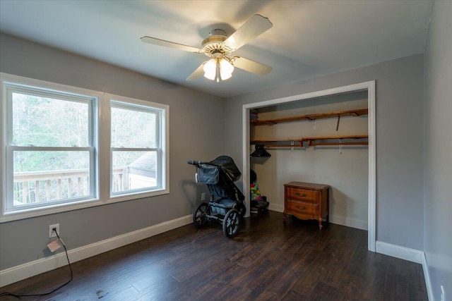 bedroom featuring a closet, baseboards, and wood finished floors