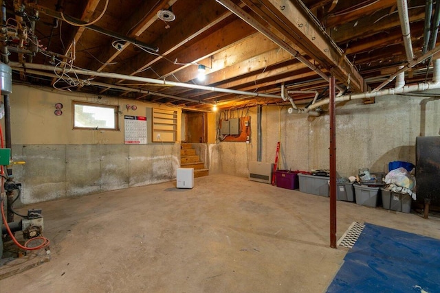 basement featuring electric panel and stairway