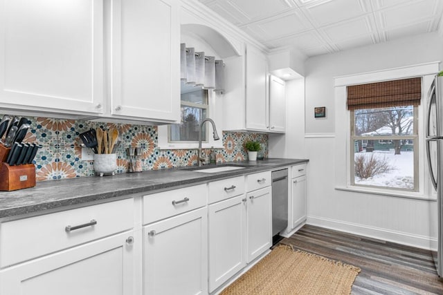 kitchen featuring an ornate ceiling, a sink, dark wood-type flooring, white cabinets, and dark countertops