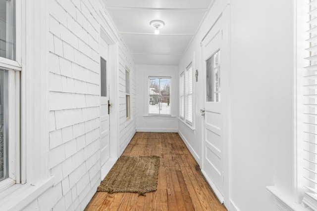 doorway to outside with baseboards and hardwood / wood-style flooring