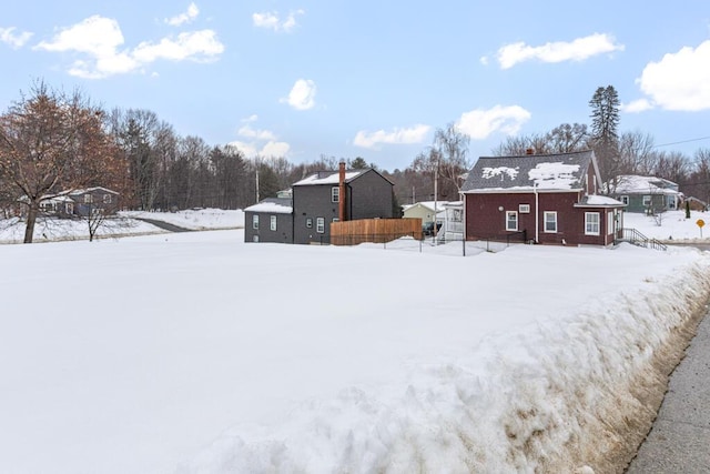 snowy yard with fence