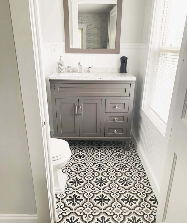 bathroom featuring tile patterned floors, toilet, and vanity