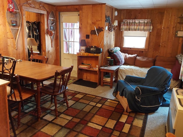 dining room with wood walls