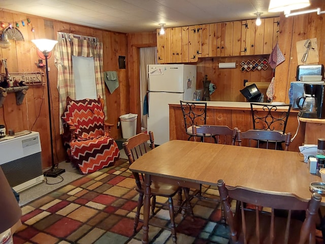 dining area with wooden walls