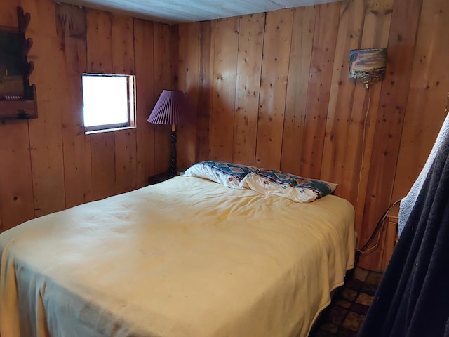 bedroom featuring wood walls