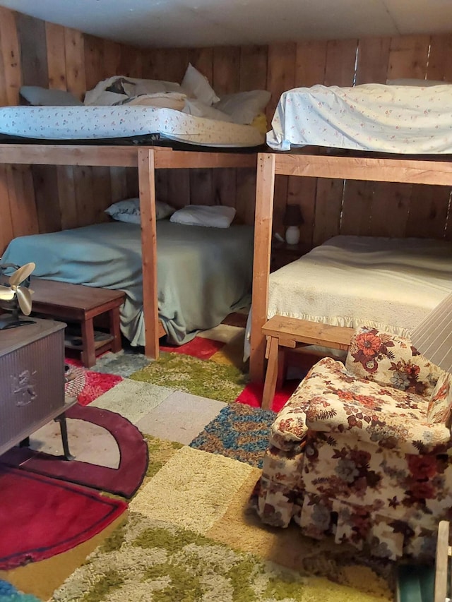 bedroom featuring wood walls