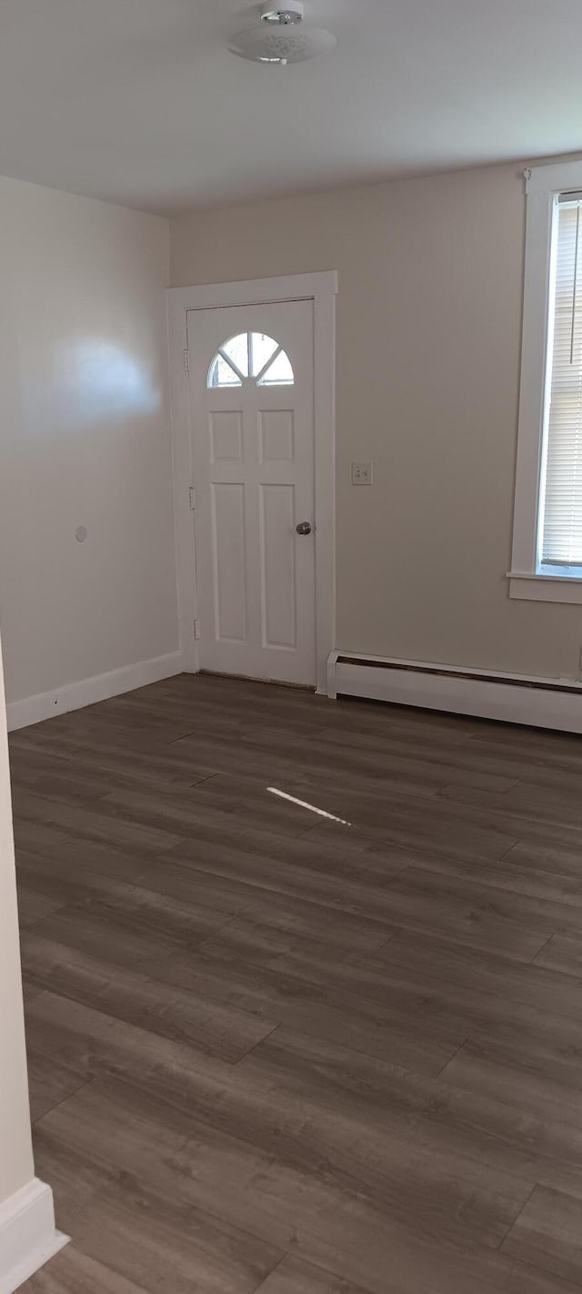 entrance foyer featuring wood finished floors, baseboards, and a baseboard radiator