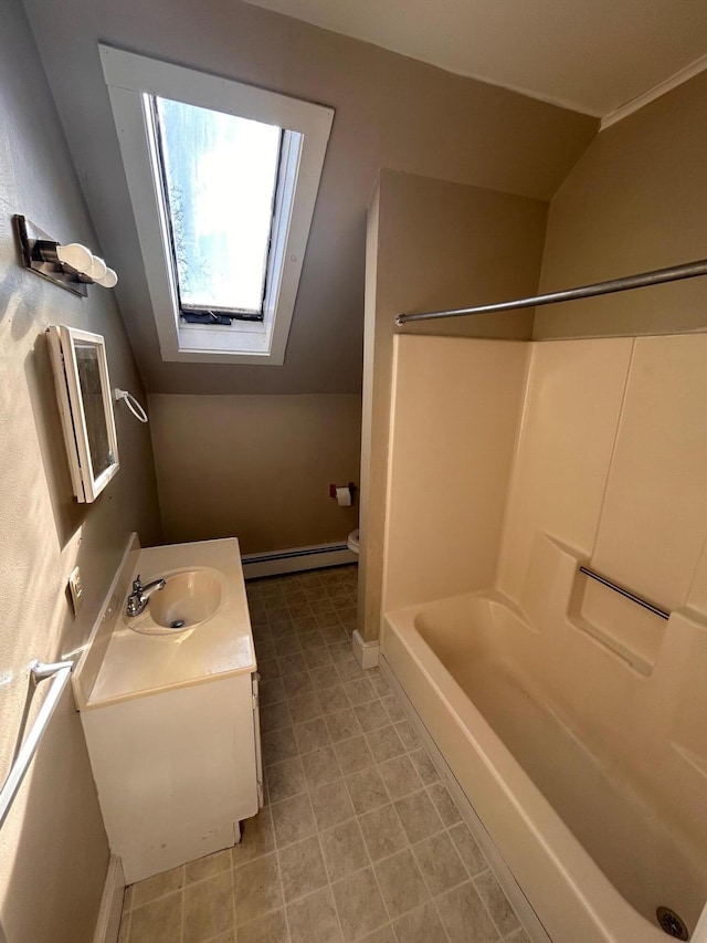 bathroom featuring baseboards, lofted ceiling with skylight, shower / bathing tub combination, vanity, and a baseboard radiator