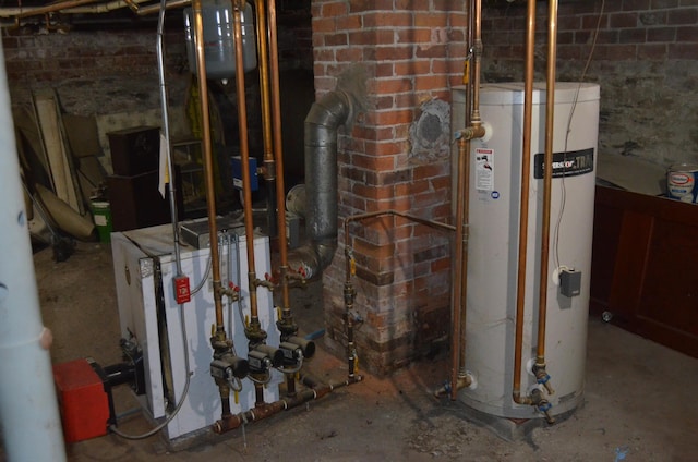 utility room featuring water heater and a heating unit