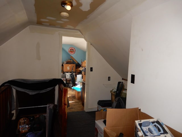 bonus room featuring vaulted ceiling and wood finished floors