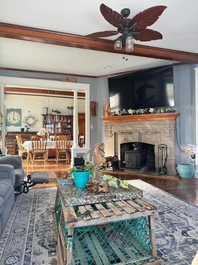 living room with ceiling fan, decorative columns, and wood finished floors