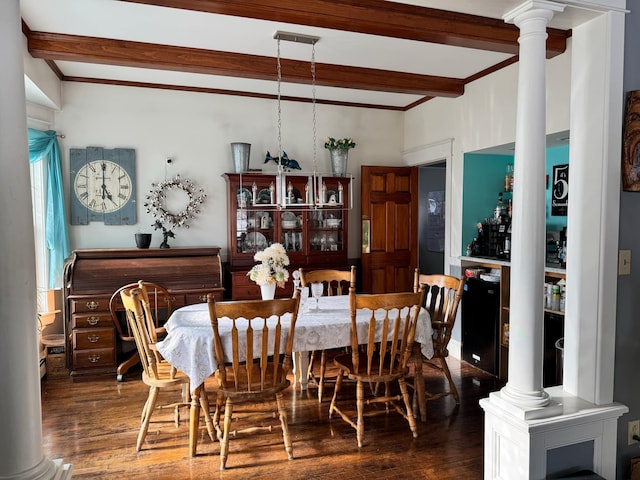 dining room featuring beamed ceiling, wood finished floors, and ornate columns