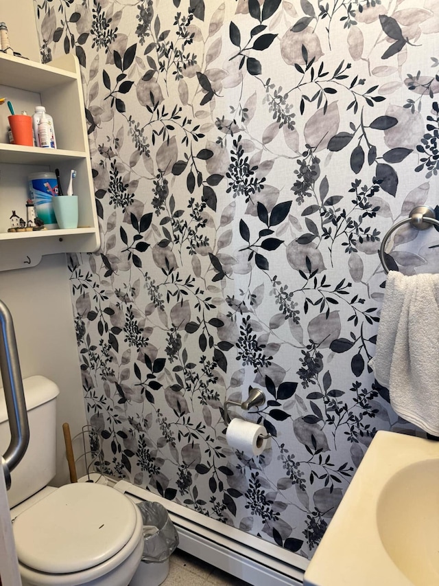 bathroom with a baseboard radiator, a sink, and toilet