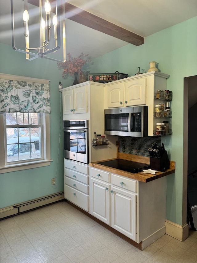 kitchen with a baseboard radiator, wooden counters, appliances with stainless steel finishes, beam ceiling, and light floors