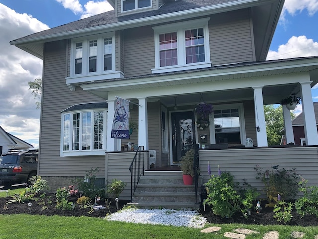 traditional style home featuring covered porch