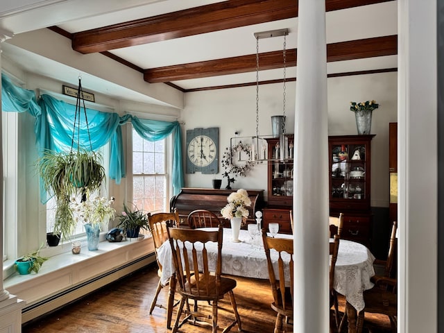 dining room with a baseboard heating unit, beamed ceiling, and wood finished floors