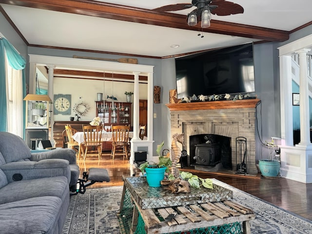 living area with ornamental molding, wood finished floors, beam ceiling, and ornate columns