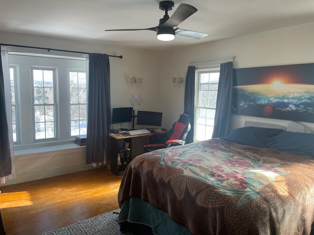 bedroom with a ceiling fan and wood finished floors