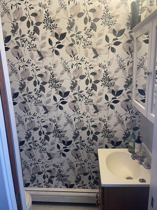 bathroom featuring toilet, a baseboard radiator, and vanity