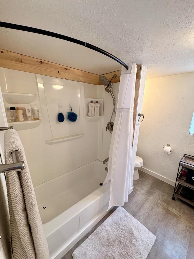 full bath with shower / bath combination with curtain, a textured ceiling, toilet, and baseboards