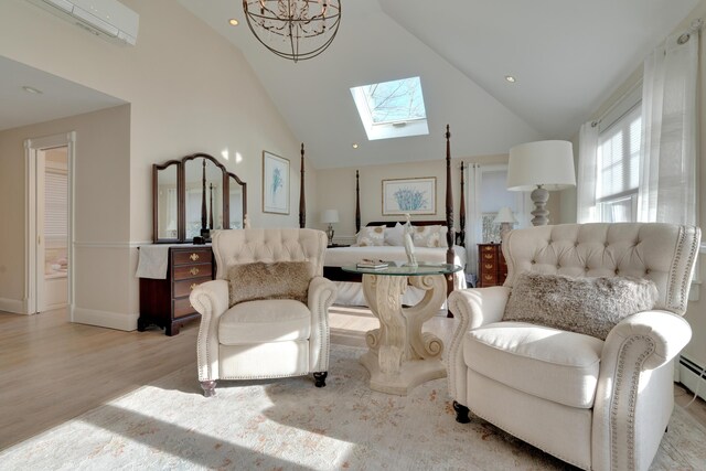 interior space featuring light wood-style floors, a skylight, high vaulted ceiling, and a wall unit AC