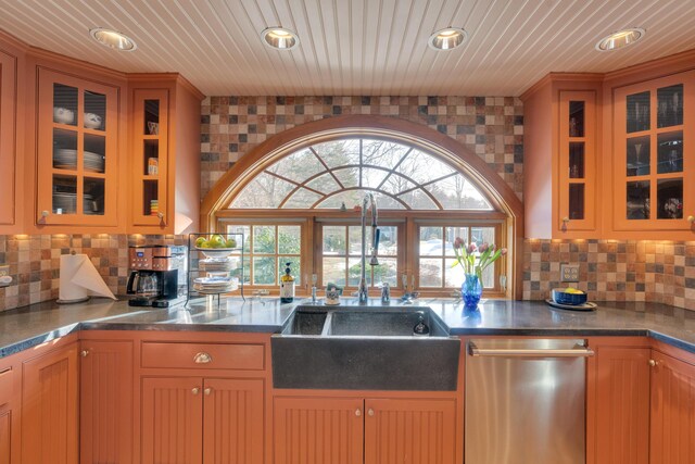 kitchen featuring decorative backsplash, recessed lighting, dishwasher, and glass insert cabinets