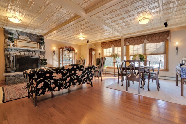 dining area with a fireplace, a healthy amount of sunlight, and an ornate ceiling