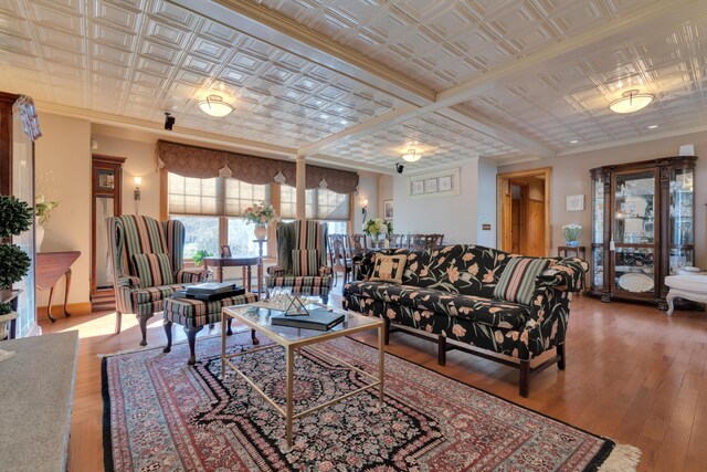 living area featuring an ornate ceiling, hardwood / wood-style floors, and crown molding