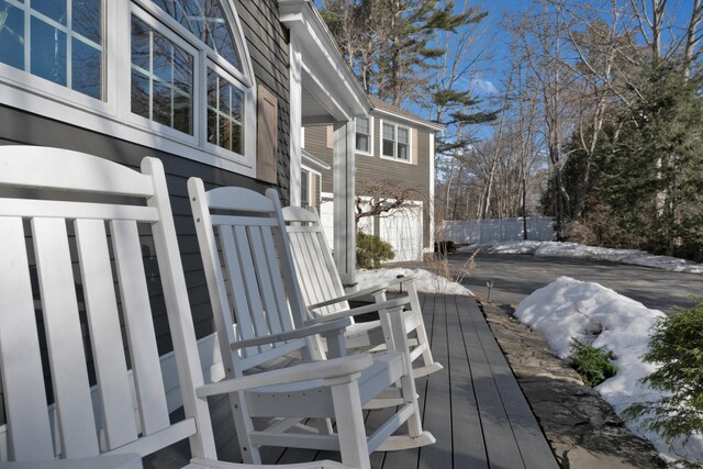 wooden deck featuring a garage