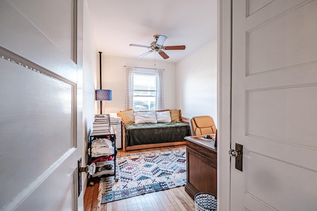 bedroom featuring light wood-style flooring and a ceiling fan