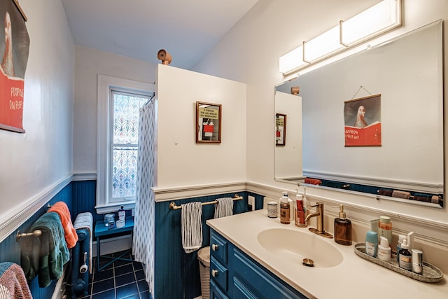 bathroom with vanity, tile patterned floors, and a wainscoted wall