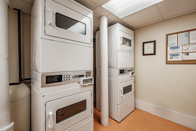 community laundry room featuring stacked washer and dryer