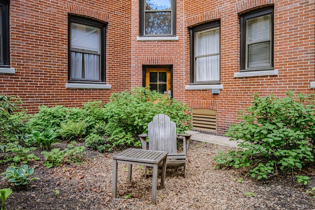 entrance to property featuring brick siding