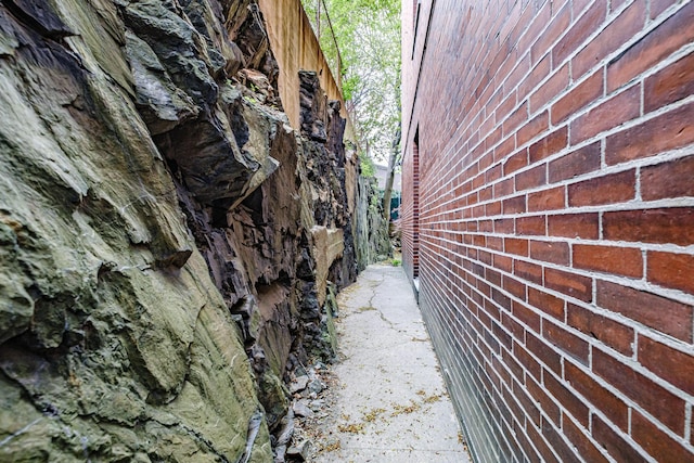 view of side of property featuring brick siding