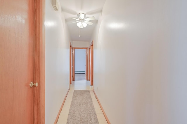 corridor featuring baseboards and baseboard heating