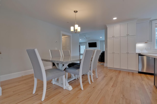 dining room featuring light wood finished floors, a notable chandelier, recessed lighting, and baseboards