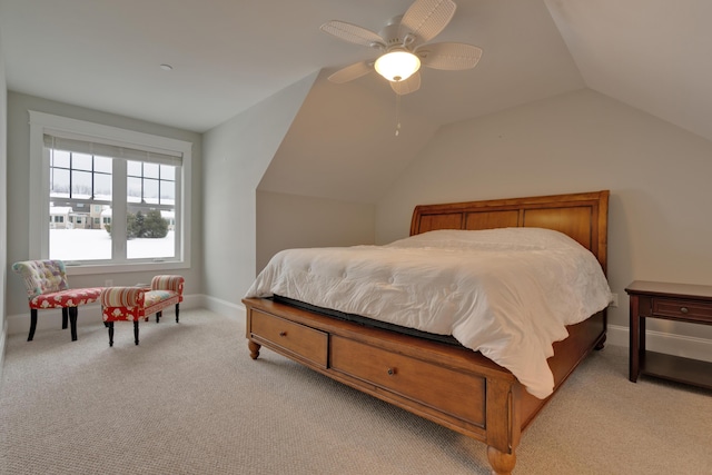 bedroom with ceiling fan, vaulted ceiling, baseboards, and light carpet