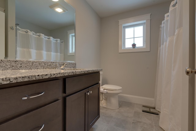 full bath with baseboards, toilet, and vanity