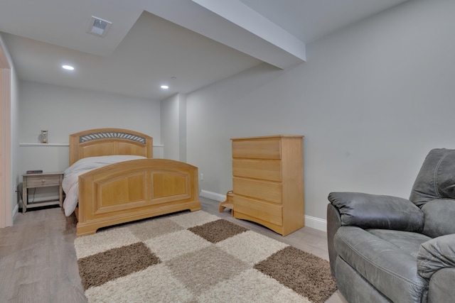 bedroom with light wood-type flooring, visible vents, baseboards, and recessed lighting