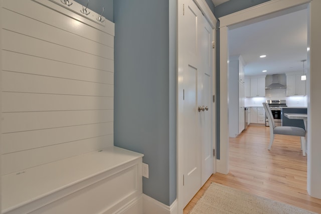 corridor featuring recessed lighting, light wood-style flooring, and baseboards