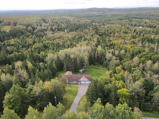 bird's eye view featuring a wooded view