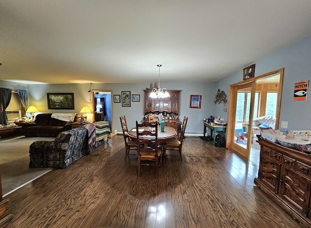 dining area featuring an inviting chandelier, dark wood-type flooring, french doors, and a baseboard radiator