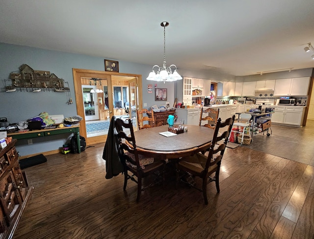 dining area featuring a notable chandelier and dark wood-style floors