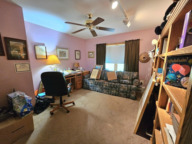 carpeted home office featuring ceiling fan and rail lighting