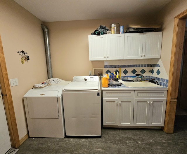 laundry area with a sink, cabinet space, and washer and clothes dryer