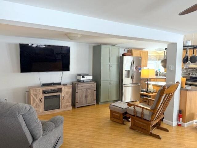 living room with light wood-style flooring and a ceiling fan